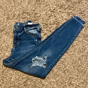 Women's size 2 high waisted ripped blue skinny jeans.